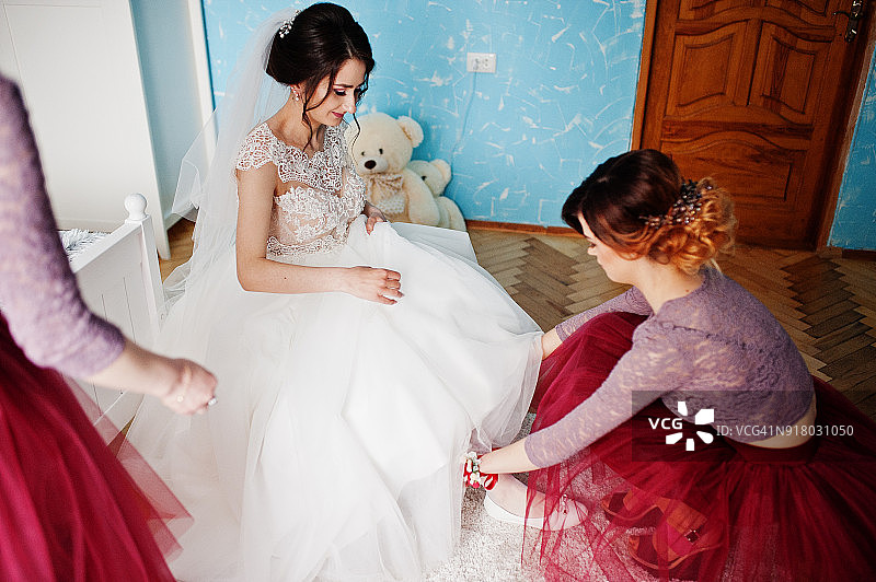 美丽的新娘和伴娘在她的房间摆姿势图片素材