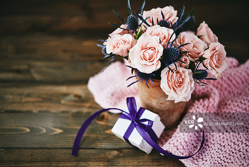 手工制作的母亲节花束与粉红色的玫瑰和礼物在乡村设置图片素材