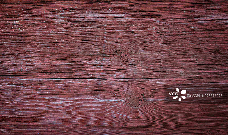 一个旧的和褪色的木板墙的特写，在红色与vignette图片素材