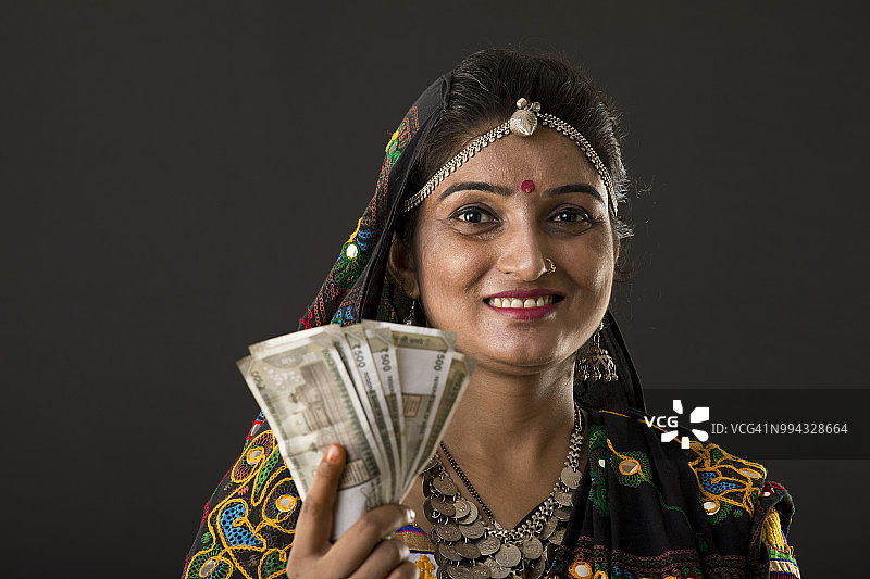 印度妇女持有纸币图片素材