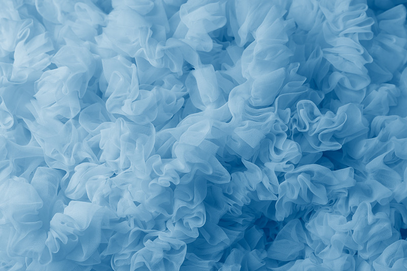 蓝色轻量织物网，织物质地，美丽的褶皱背景。图片下载