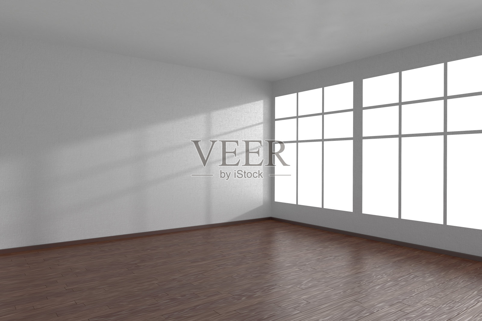 白色房间的一角，有大窗户和深色拼花地板照片摄影图片