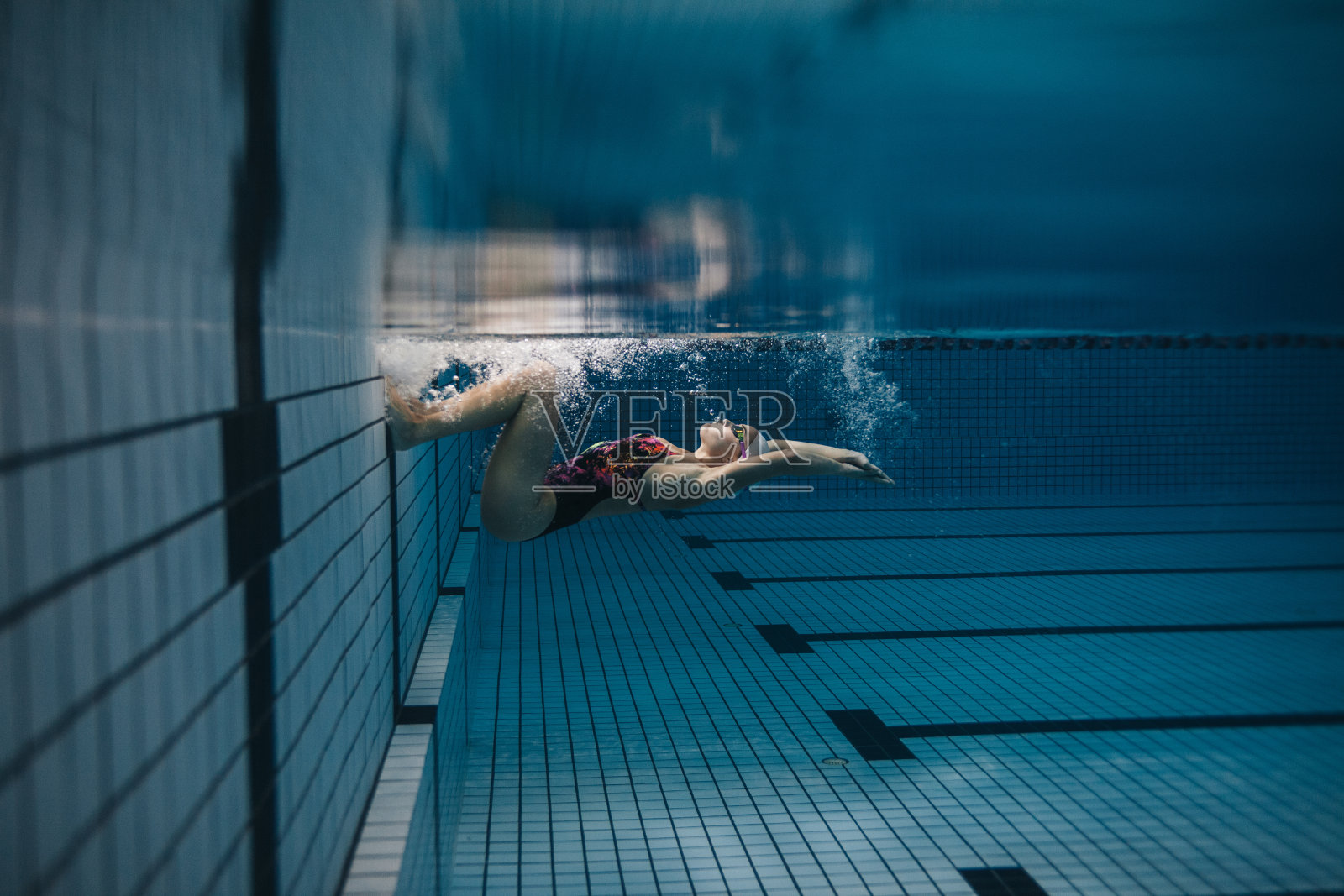 女游泳运动员在游泳池内的行动照片摄影图片