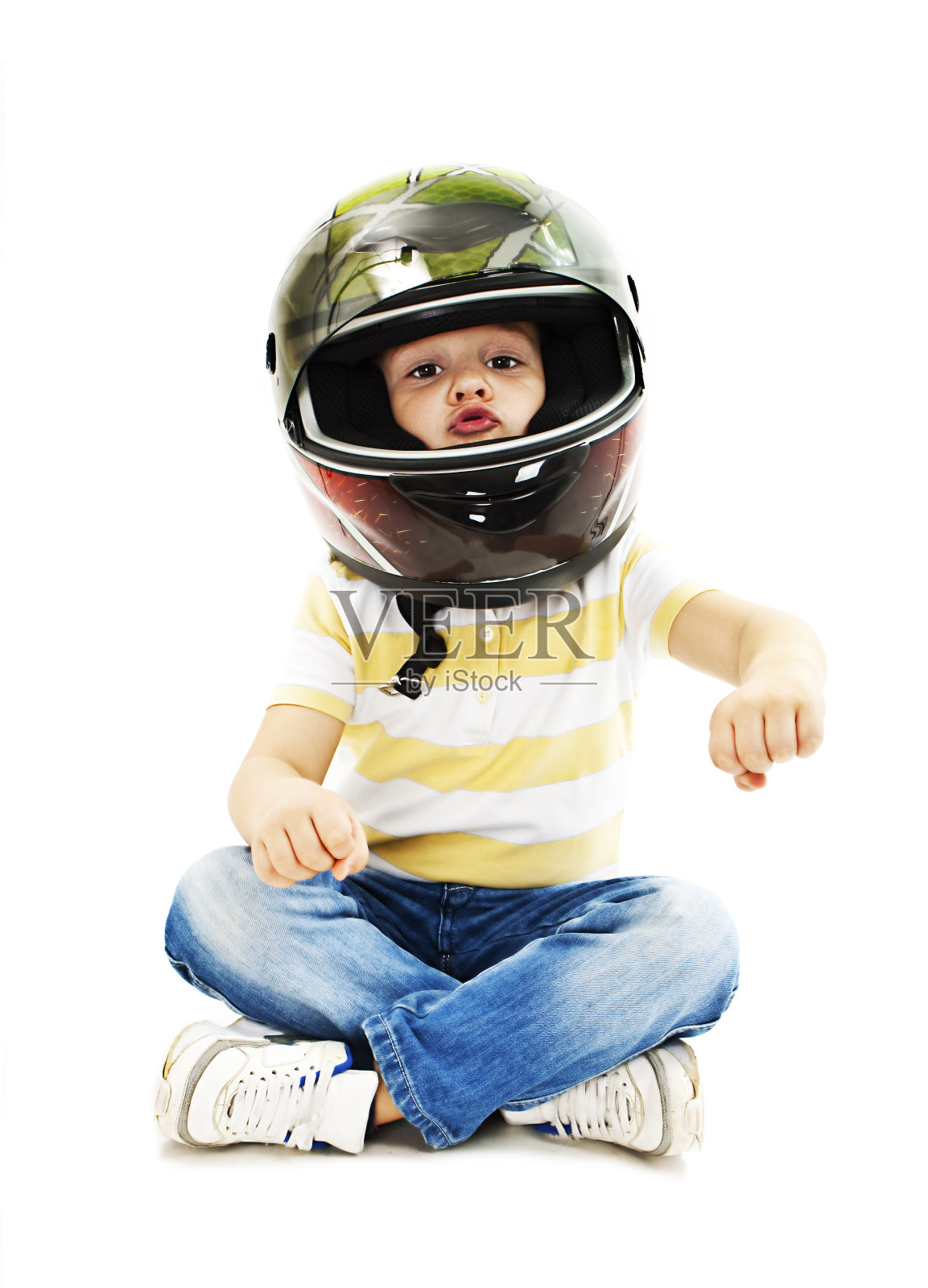 戴着头盔假装开摩托车的男孩照片摄影图片