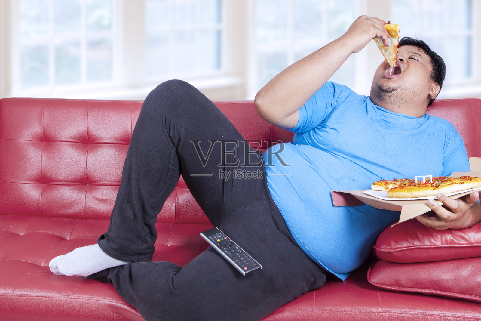 胖男人吃披萨照片摄影图片