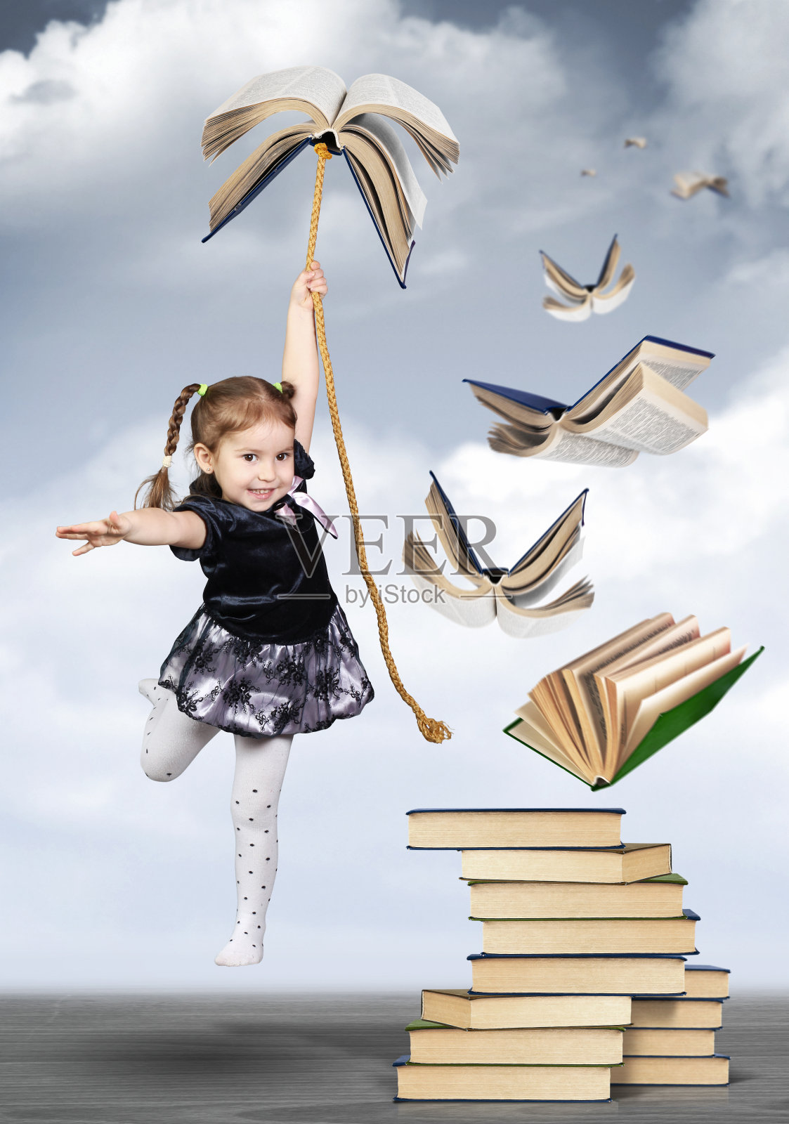 教育理念创新，童女孩飞上书本照片摄影图片