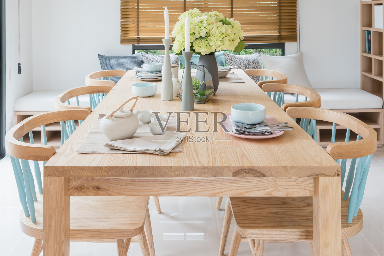 现代餐厅的木制餐桌，配有餐桌和植物花瓶照片摄影图片