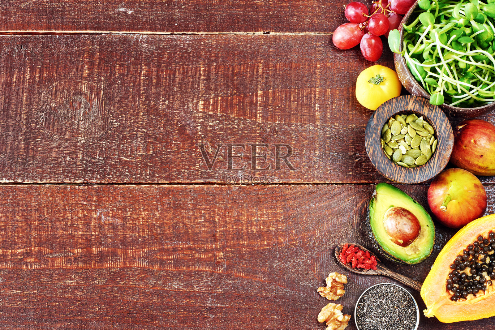 俯视图的新鲜蔬菜，水果，超级食物，坚果和种子。木质纹理背景与复制空间。照片摄影图片