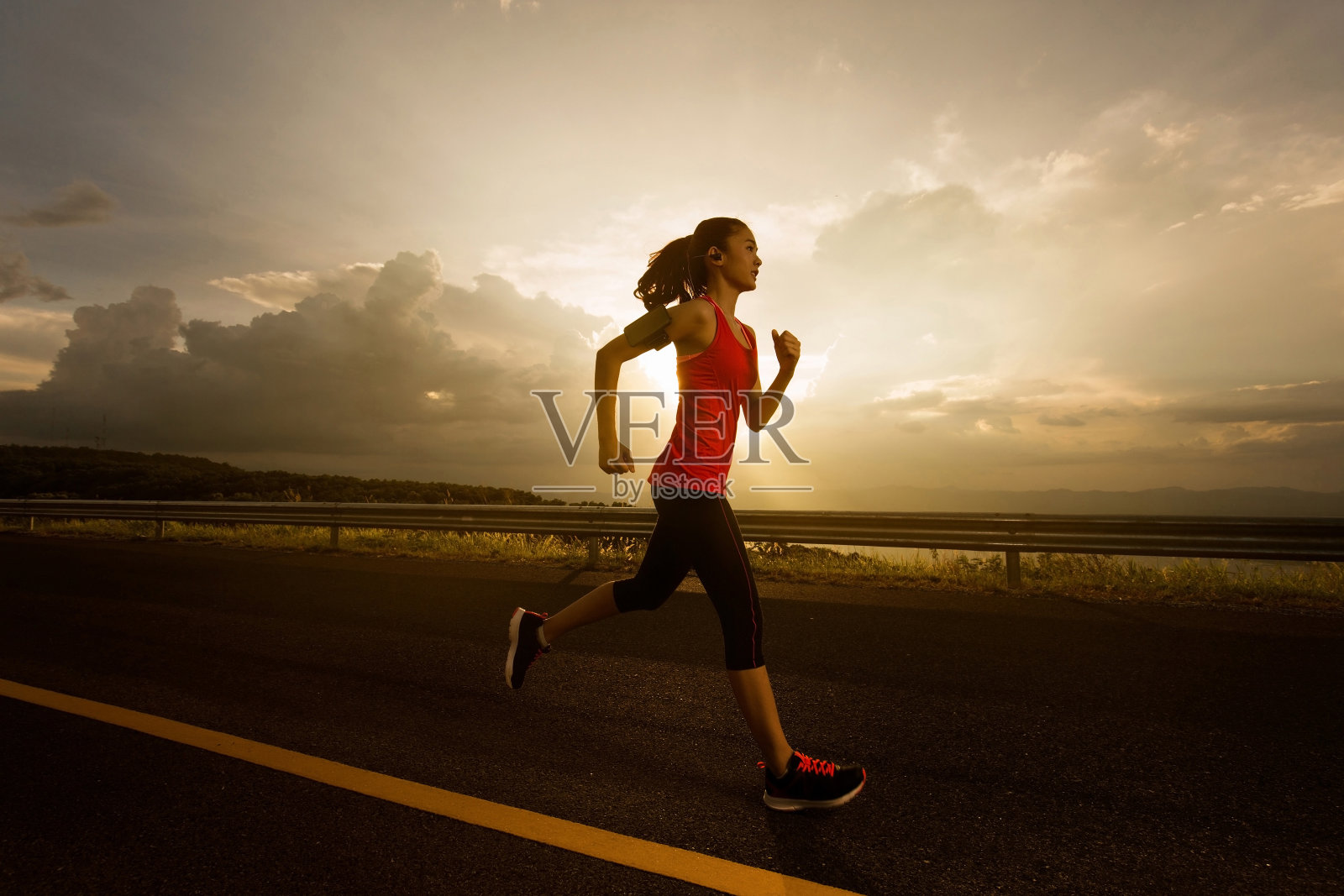 亚洲妇女早上在慢跑。跑步时听音乐照片摄影图片