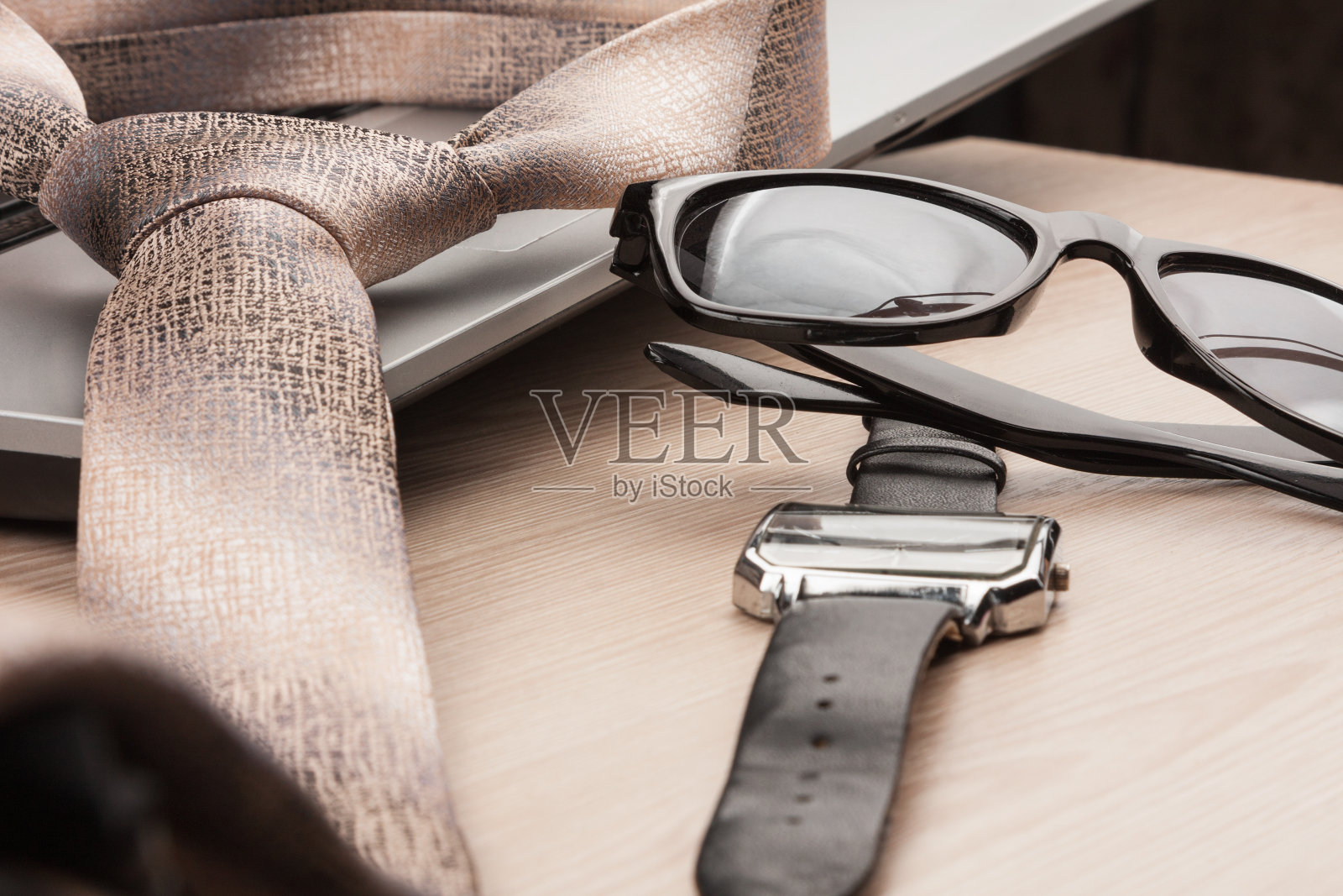 时尚和商业。特写太阳镜，领带和手表，放在一张木桌上照片摄影图片