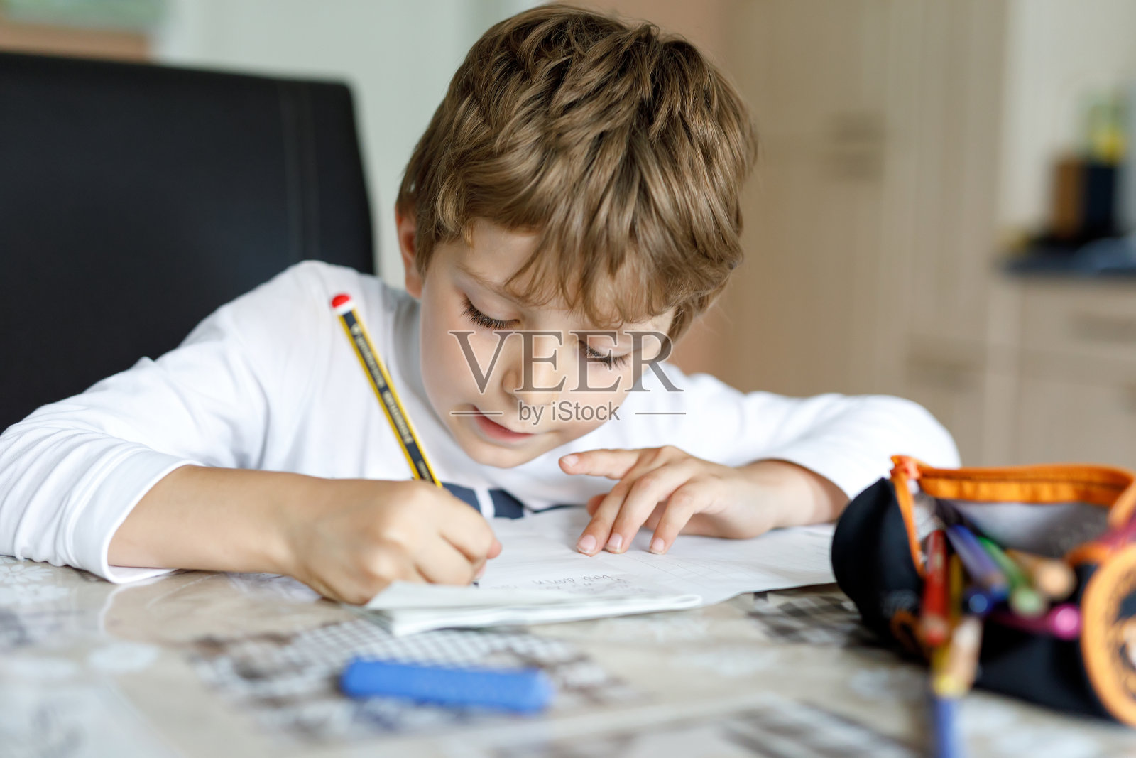 累了的小男孩在家里写作业用彩色笔写信照片摄影图片