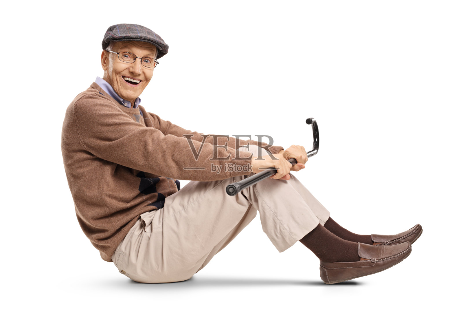 拄着拐杖坐在地板上的老人照片摄影图片