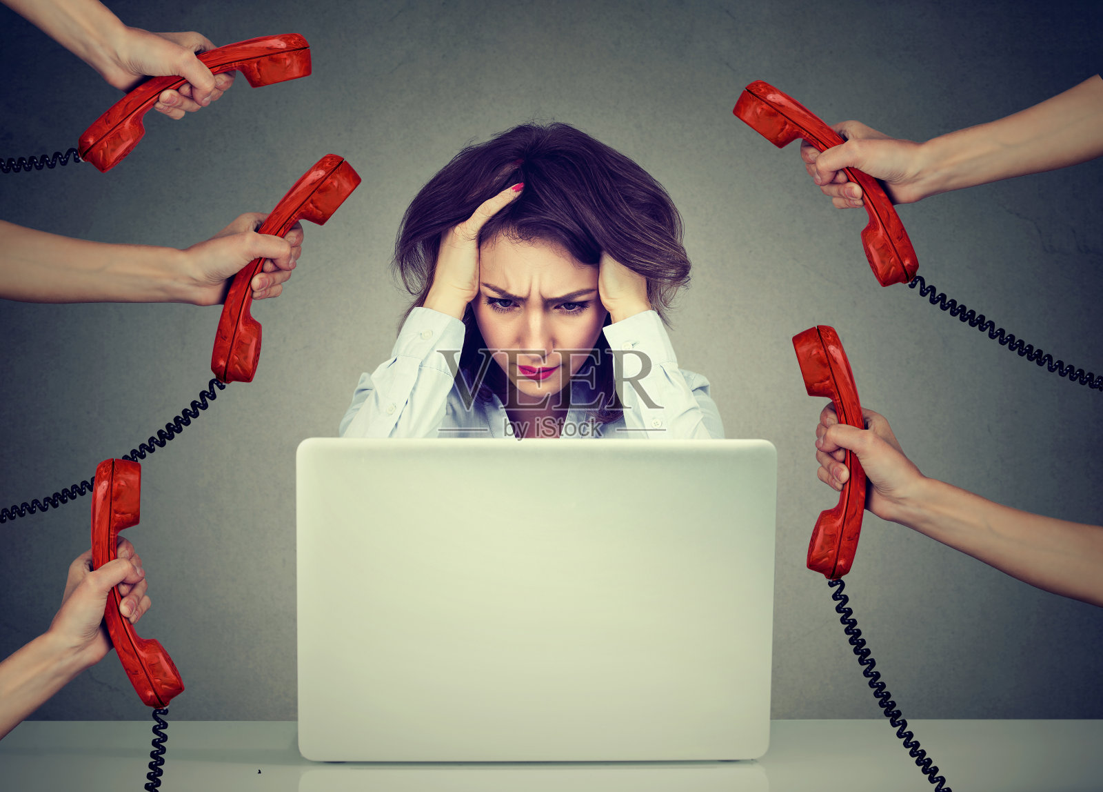 在笔记本电脑上工作的压力大的商务女性被太多的电话压垮了照片摄影图片