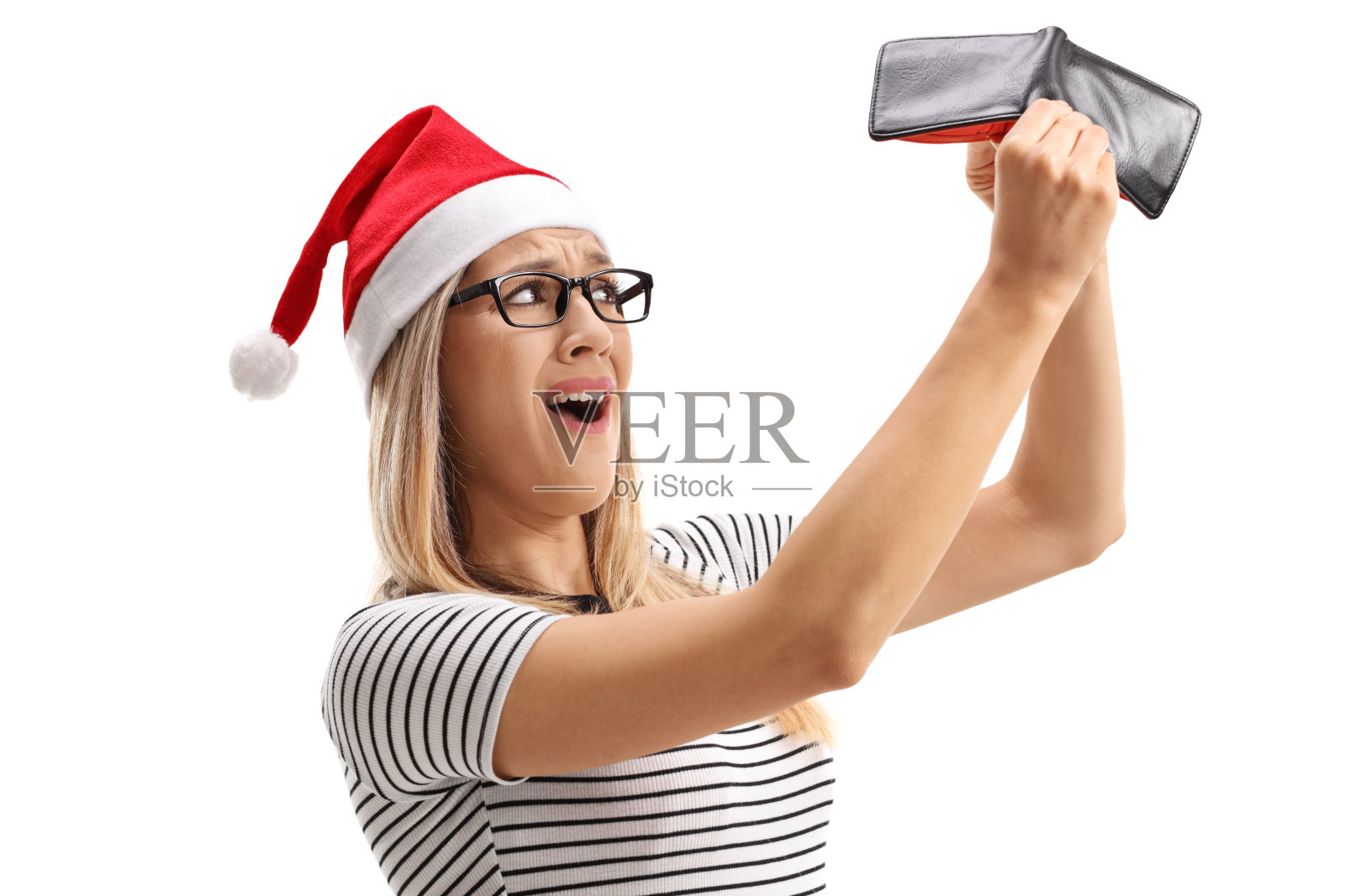 带着圣诞帽的失望女人手里拿着一个空钱包照片摄影图片