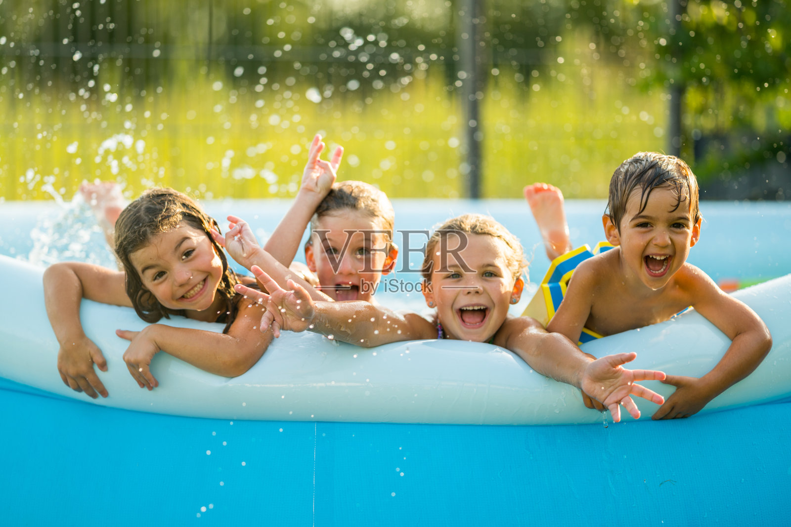 兄弟姐妹-四个快乐的孩子在游泳池里照片摄影图片