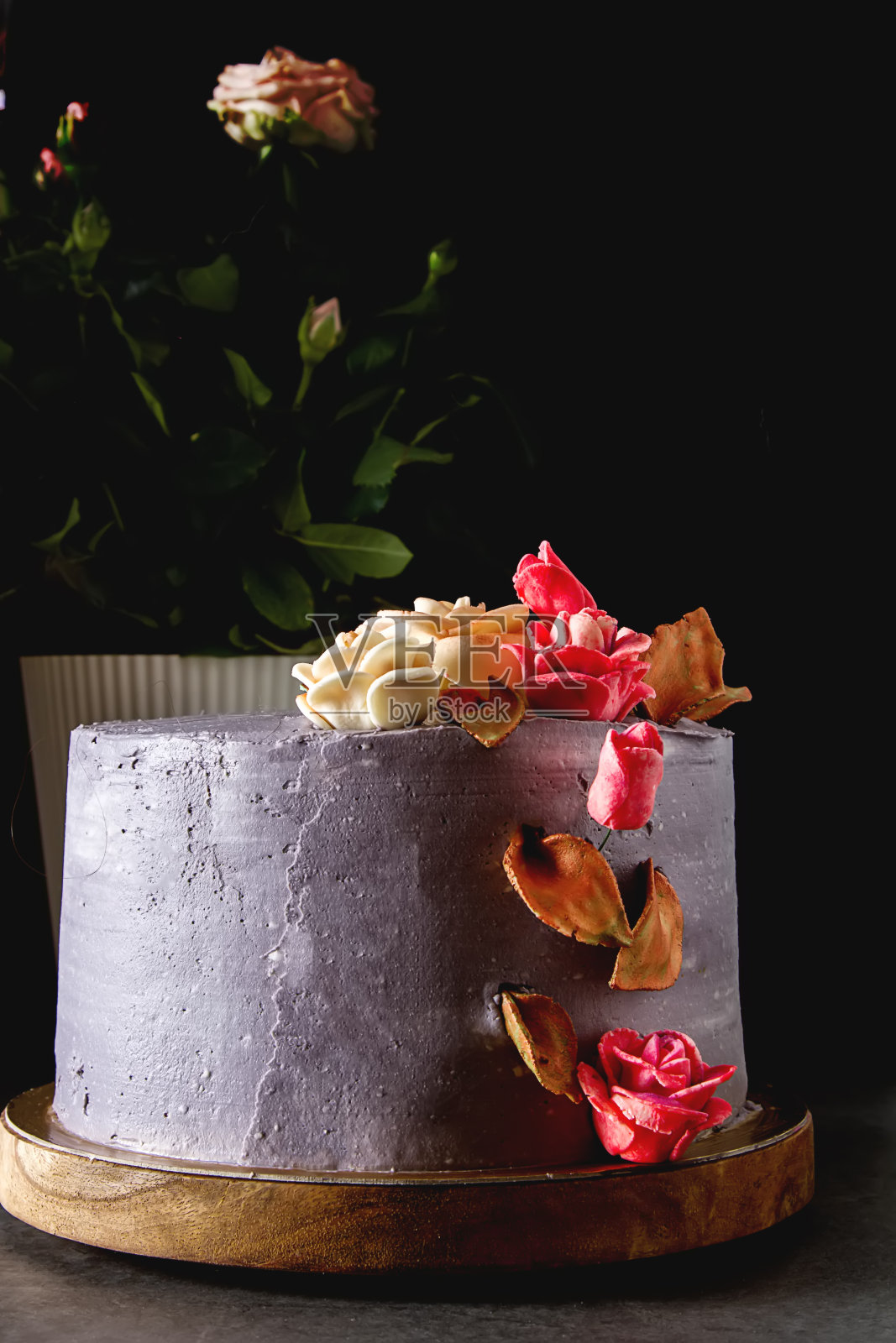 带花的生日巧克力蛋糕。黑暗的背景。照片摄影图片