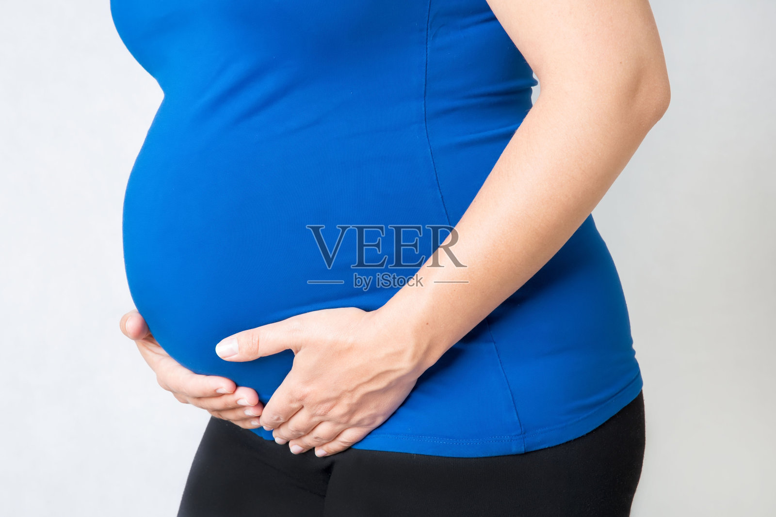 一个孕妇把手放在肚子上照片摄影图片