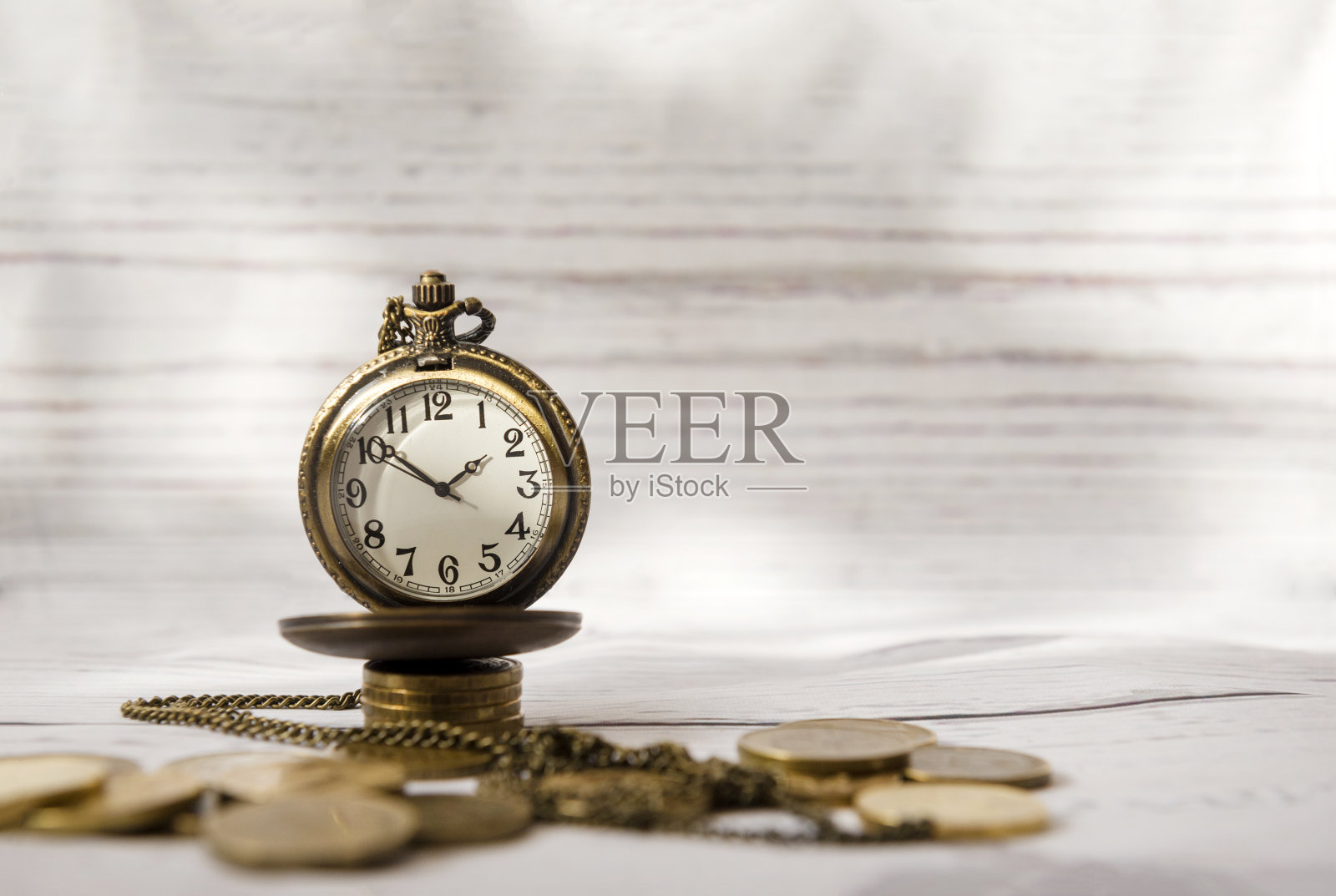时间和金钱，古董钟，怀表上一堆硬币，表脸，指针照片摄影图片