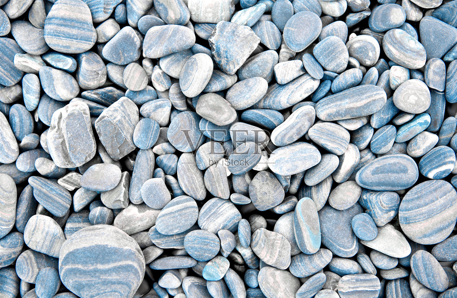 抽象的灰色干燥圆形石头背景。在海滩上。海卵石和砾石风格。前视图。关闭了。照片摄影图片