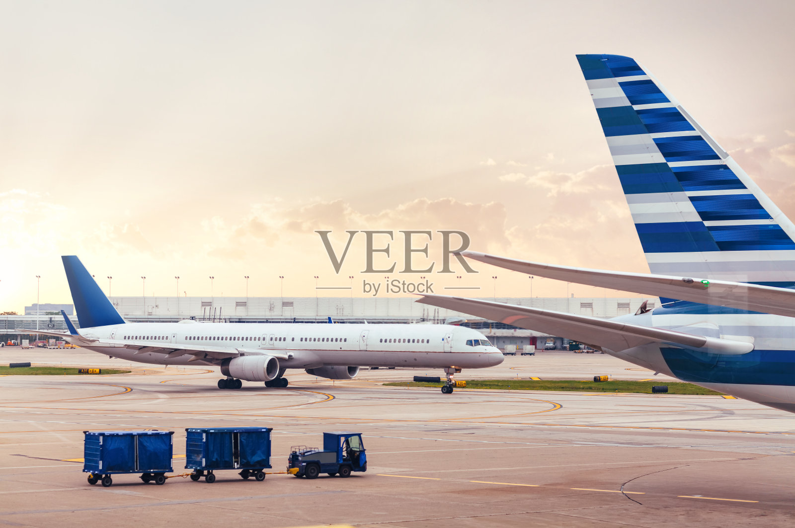 两架飞机在停机坪上，在机场装载货物照片摄影图片