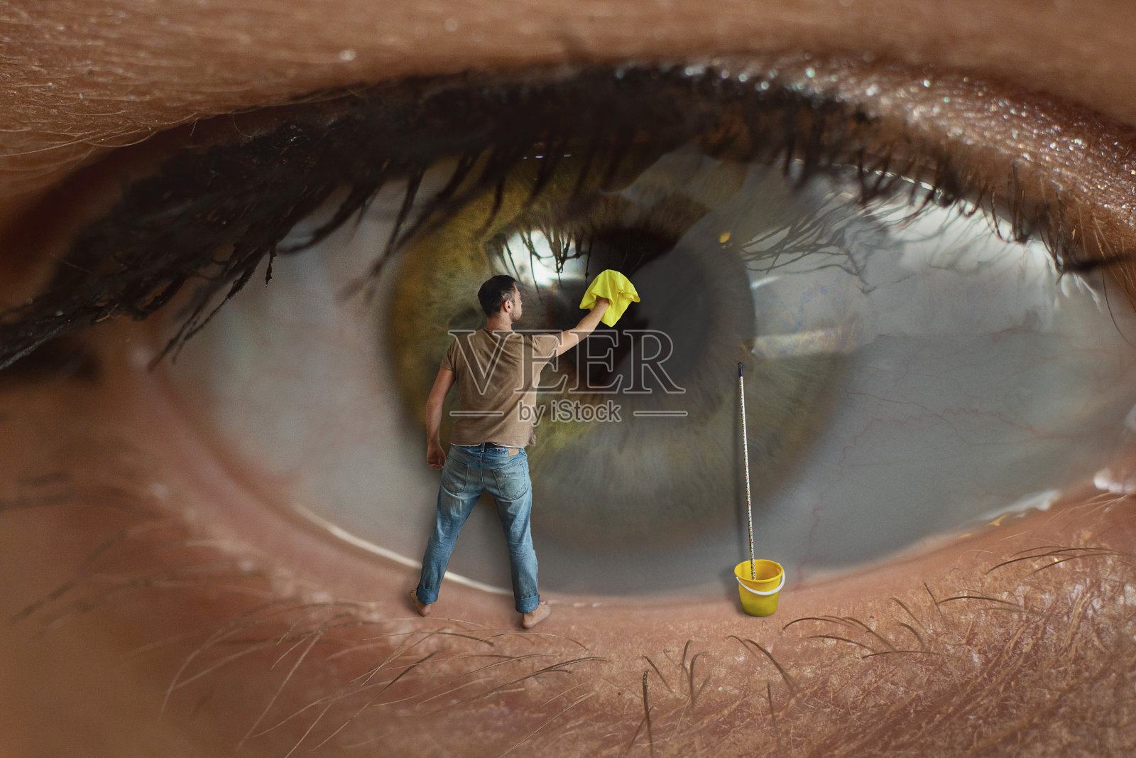 男工人用抹布擦拭瞳孔表面。健康视力，结膜炎和窗户清洁的概念。照片摄影图片