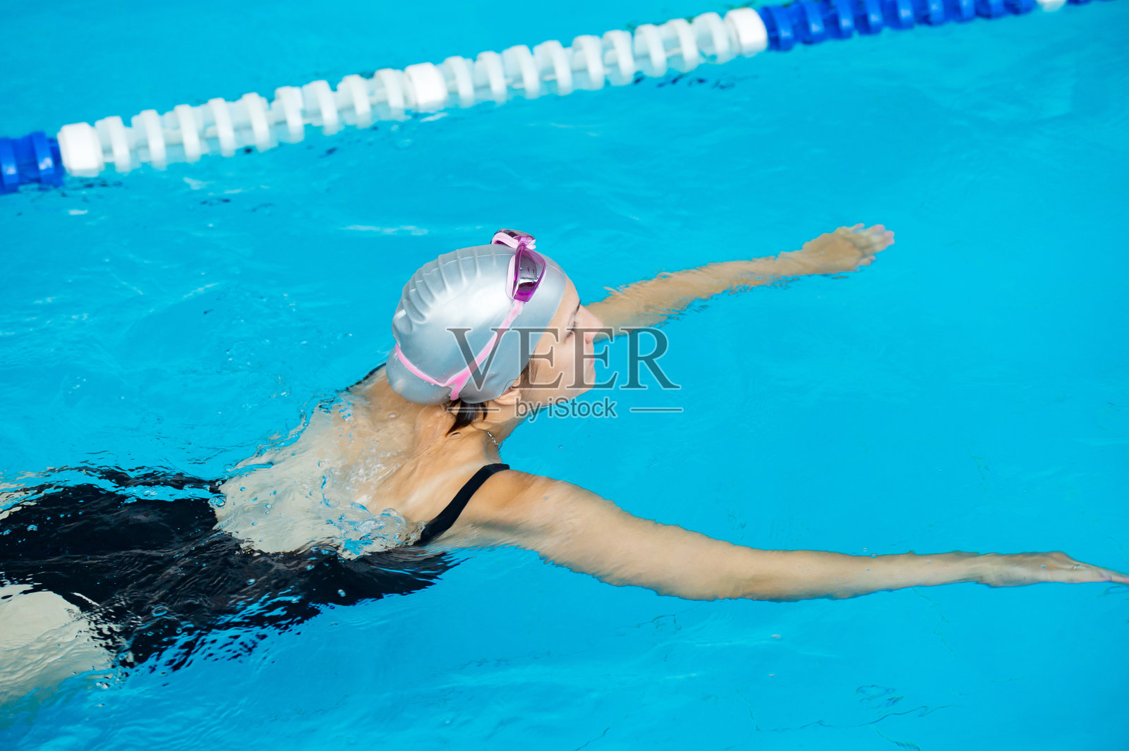 女子游泳运动员在游泳池游泳，水上运动照片摄影图片