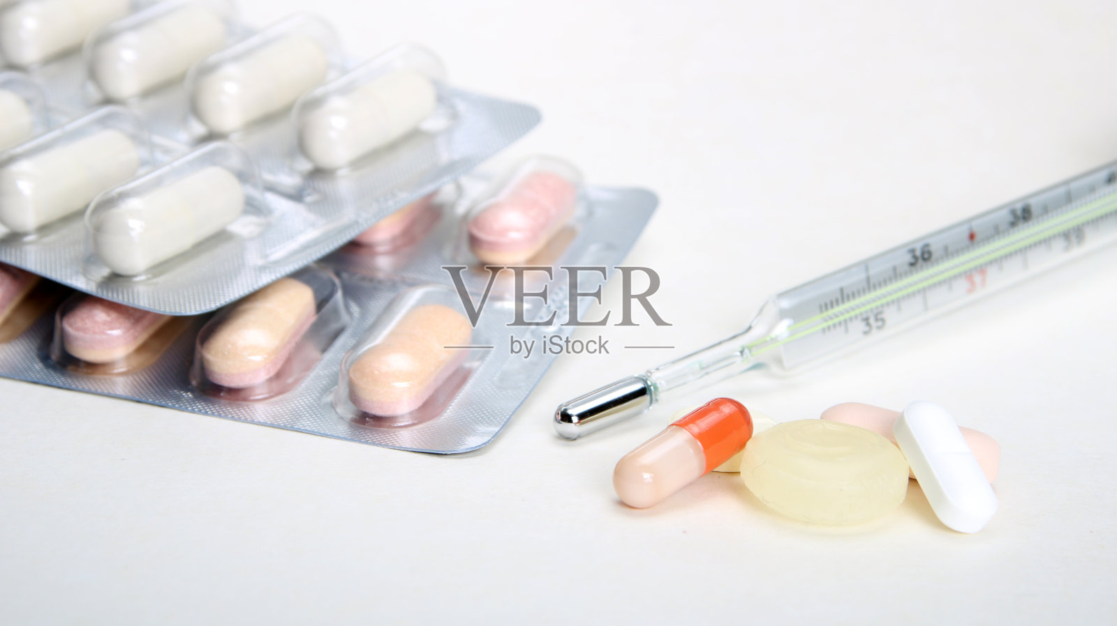 药房主题、片剂、胶囊、丸堆混合治疗药物与药物抗生素和体温计。胶囊的特写。医学概念。照片摄影图片