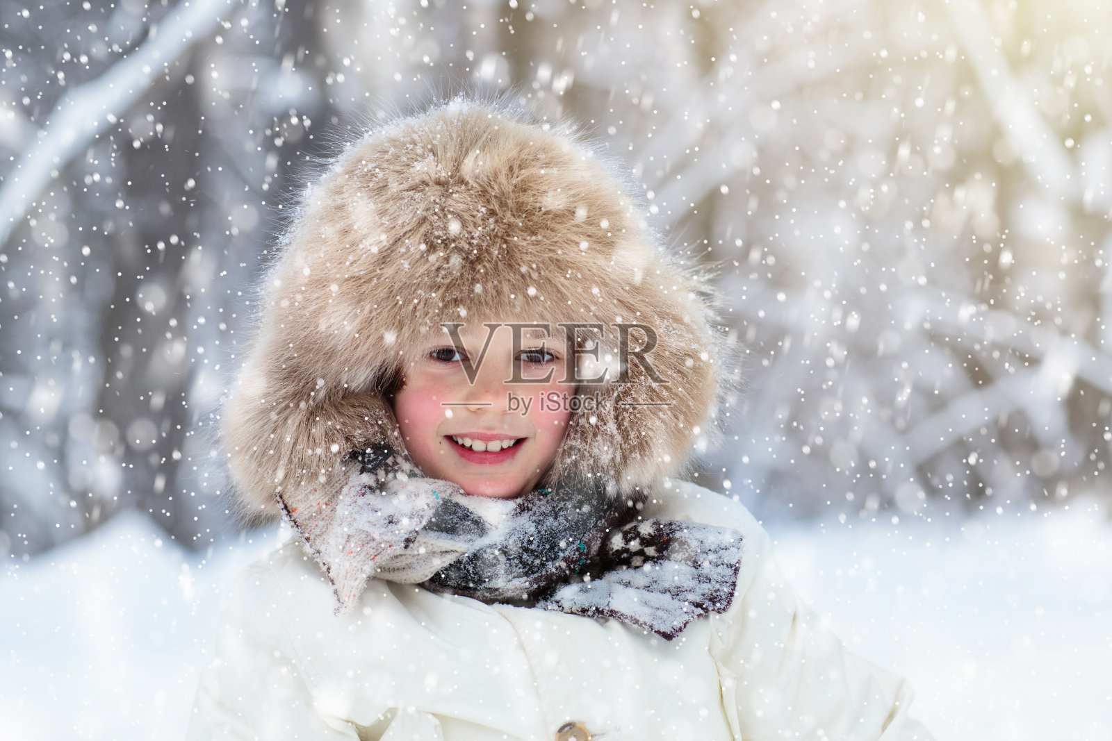 孩子们在冬天玩雪。孩子们在户外。照片摄影图片
