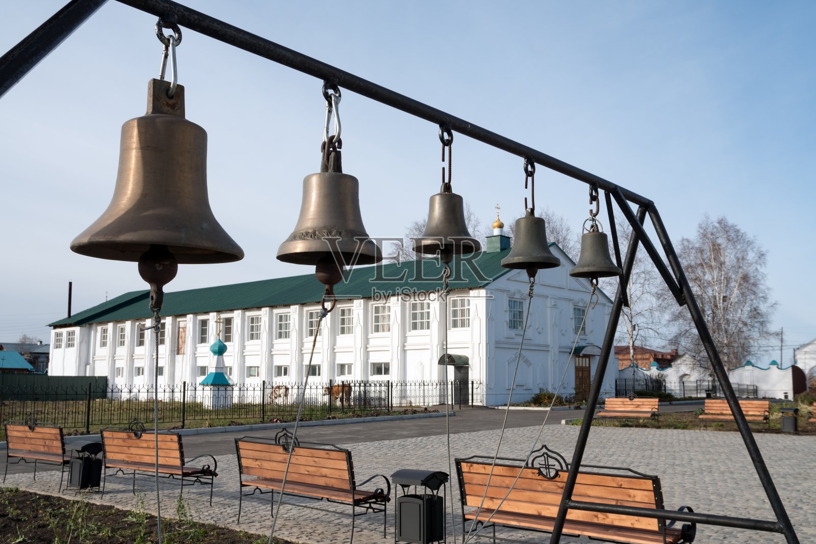 叶尼赛斯克市圣容修道院(transguration Monastery)领土上的牢房建筑背景上带有铃铛的钟楼。照片摄影图片