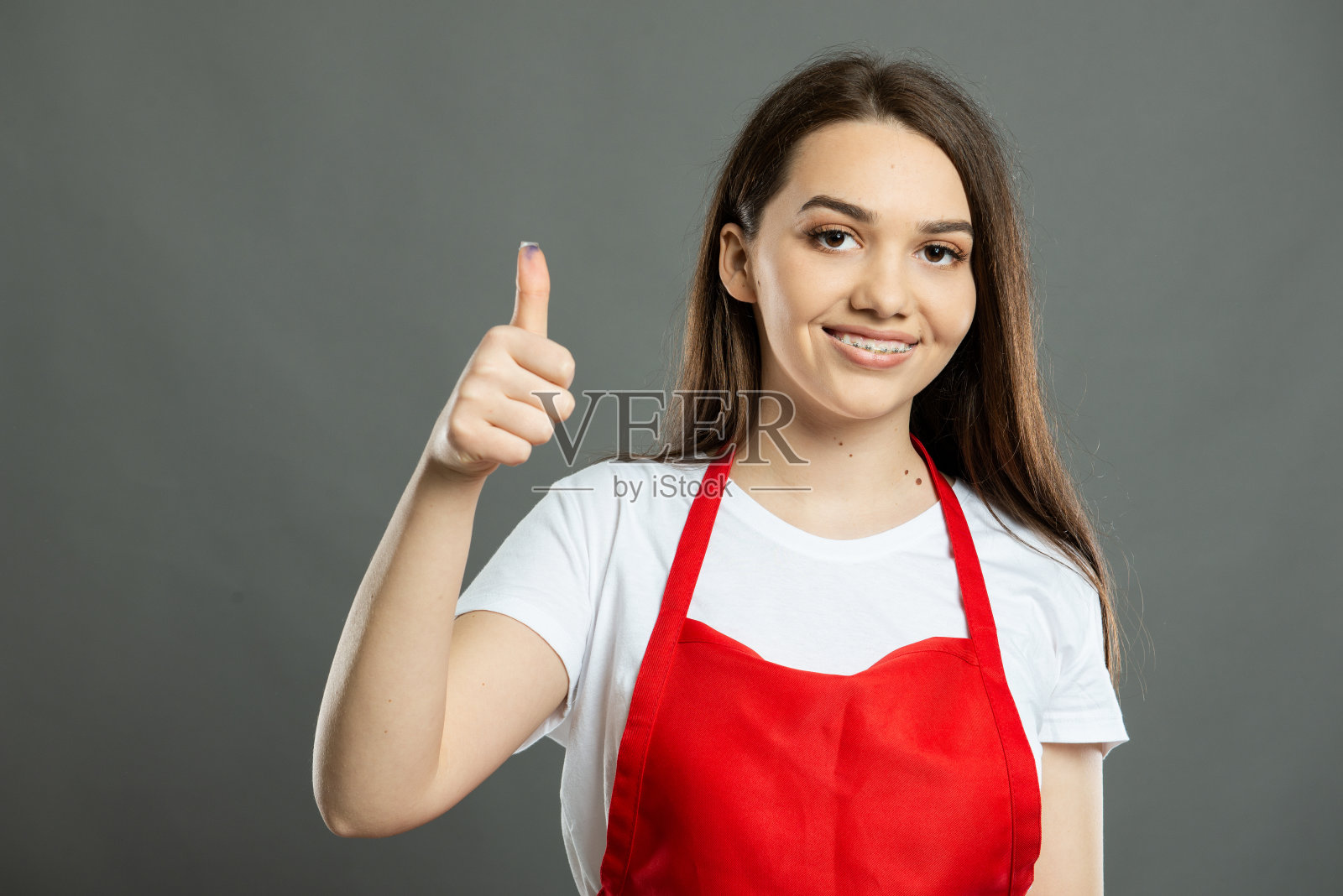 年轻女超市员工竖起大拇指的肖像照片摄影图片
