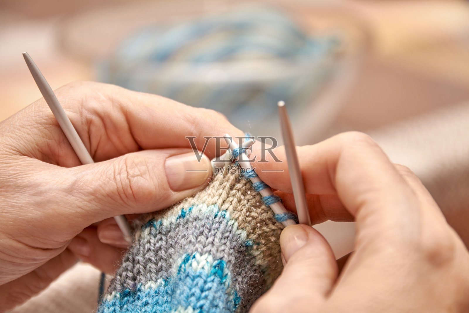 女织袜子。老年妇女的爱好是编织。近景针织圈。有选择性的重点照片摄影图片