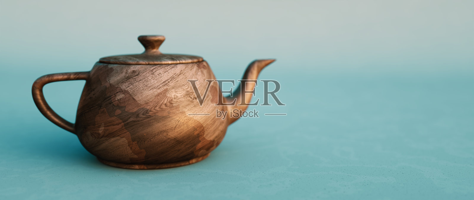 简单的木制茶壶在散焦的蓝色背景上，特写宽水平构图照片摄影图片