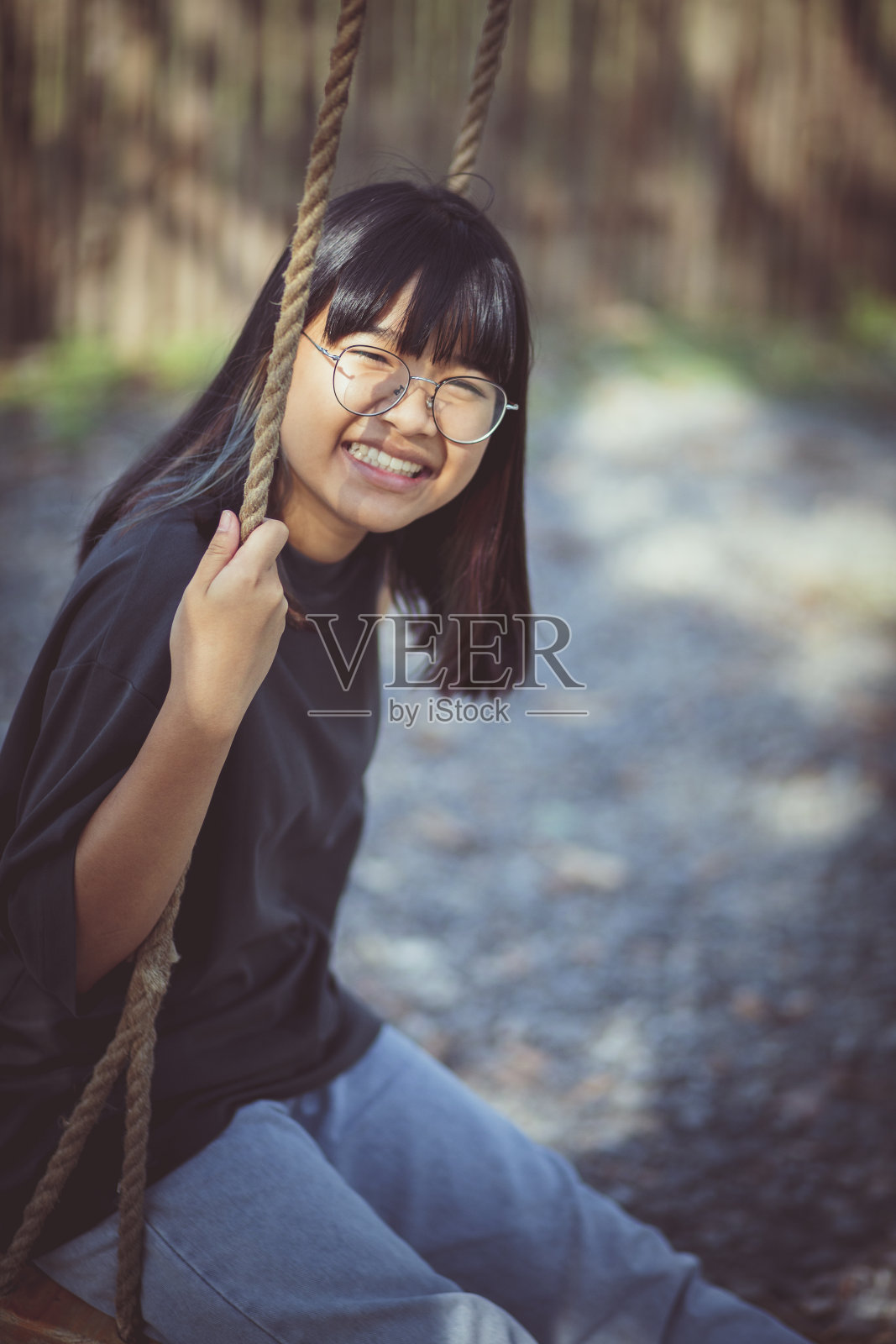 亚洲青少年在公园里放松的牙齿微笑的脸照片摄影图片