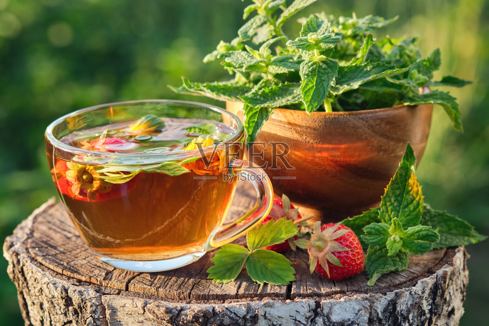 一杯含有水果、浆果和草药的健康茶。玛丽莎叶，草莓，金盏花。替代草药。照片摄影图片