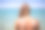 年轻女子在海滩上涂着防晒霜素材图片
