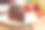 三角美味的黑巧克力软糖蛋糕顶部巧克力卷曲在白色盘子上的木桌复印空间。自制烘焙概念的生日蛋糕聚会或咖啡馆餐厅。素材图片