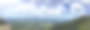 绿色山丘上的阴天全景素材图片