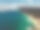 无人机空中拍摄澳大利亚海岸景观，海面云沿着海滩飞过素材图片